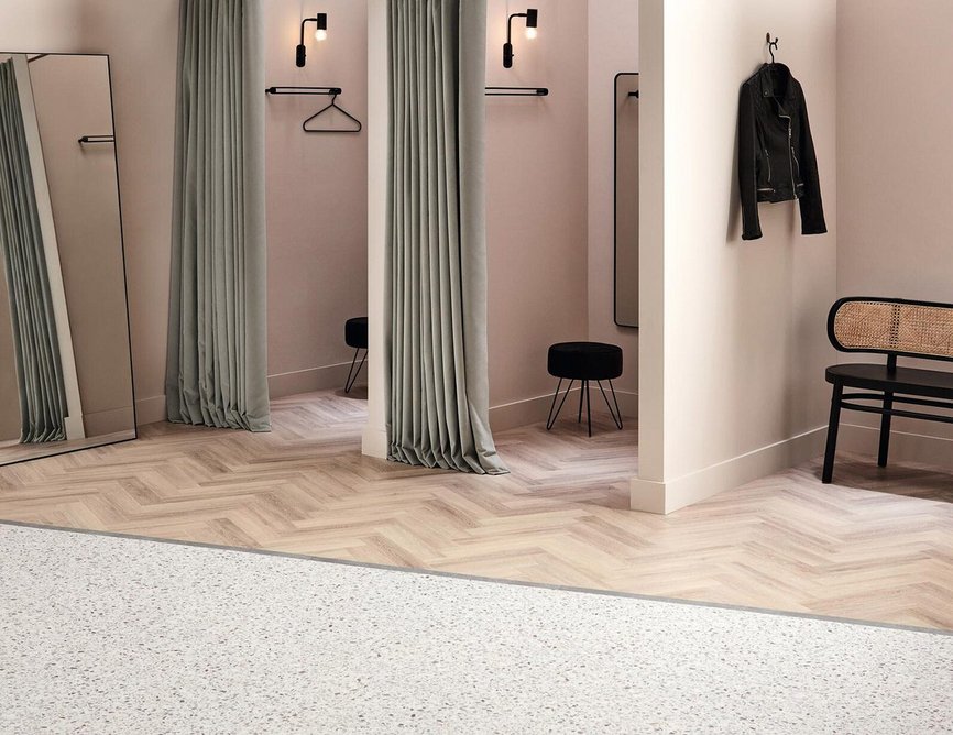Amtico Spacia Terrazzo in SS5S2603 Gibson laid in uniform tile pattern with SS5W3311 Powdered Oak laid in large parquet pattern and SS5S2631 Sea Tones stripping, all luxury vinyl tiles.