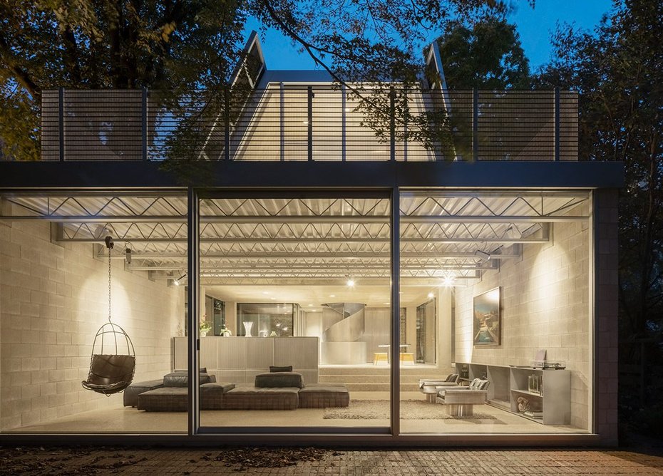 View through Foster Associates extension to Reciprocal House at night. Credit: Schnepp Renou