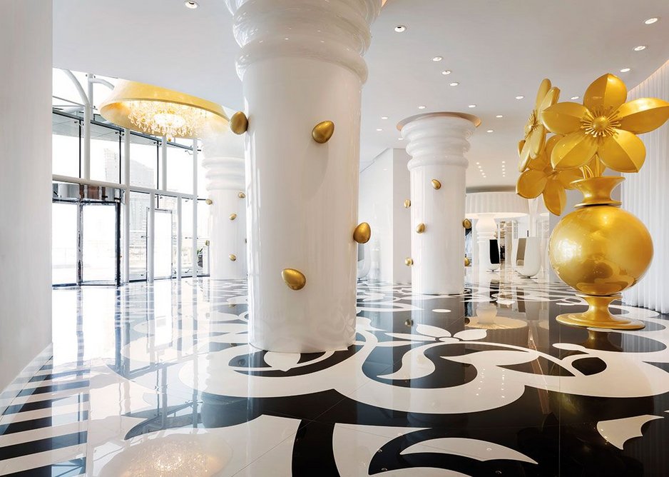 Laser-cut black and white tiles create a supersize pattern for the larger-than-life entrance lobby.