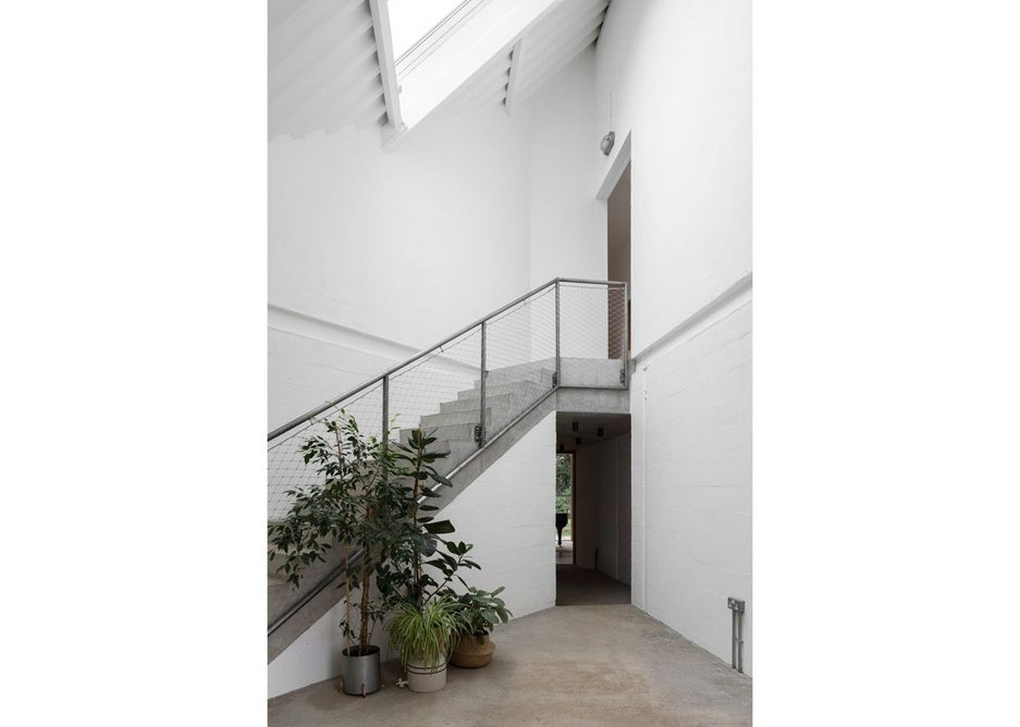 The full height entrance atrium with its concrete stair set at 45º across the plan.