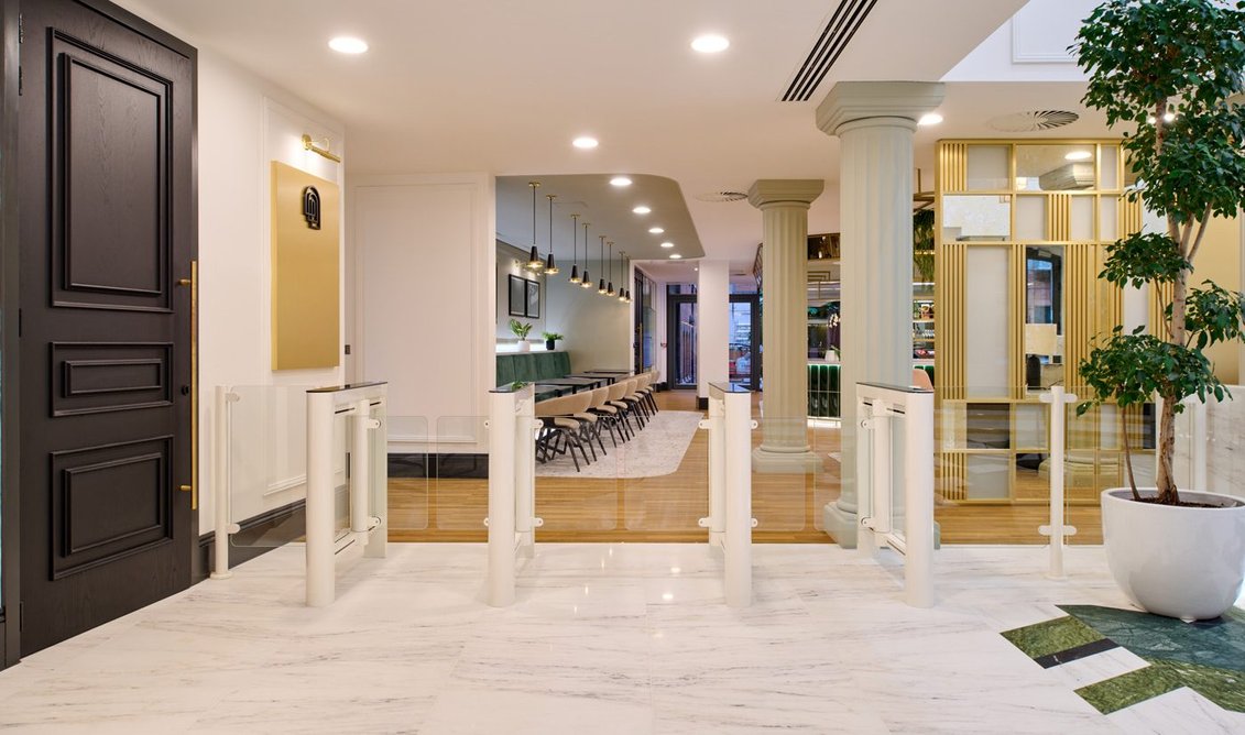 Symbiosis: specified in white with glass wings, the security solution complements the reception area's marble flooring and interior design.
