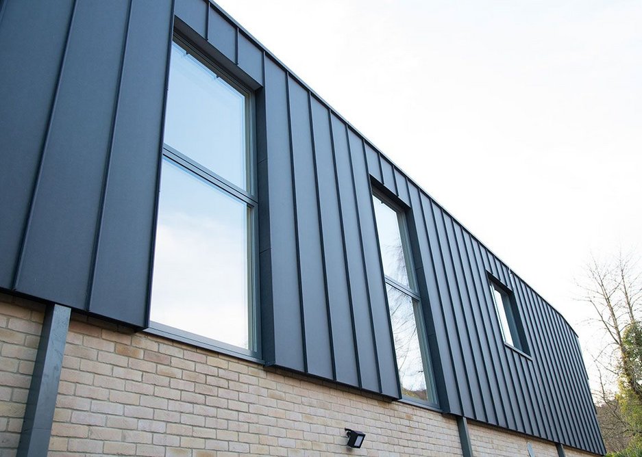 Dark grey external aluminium complements Ecclestoun's seamed aluminium roof.