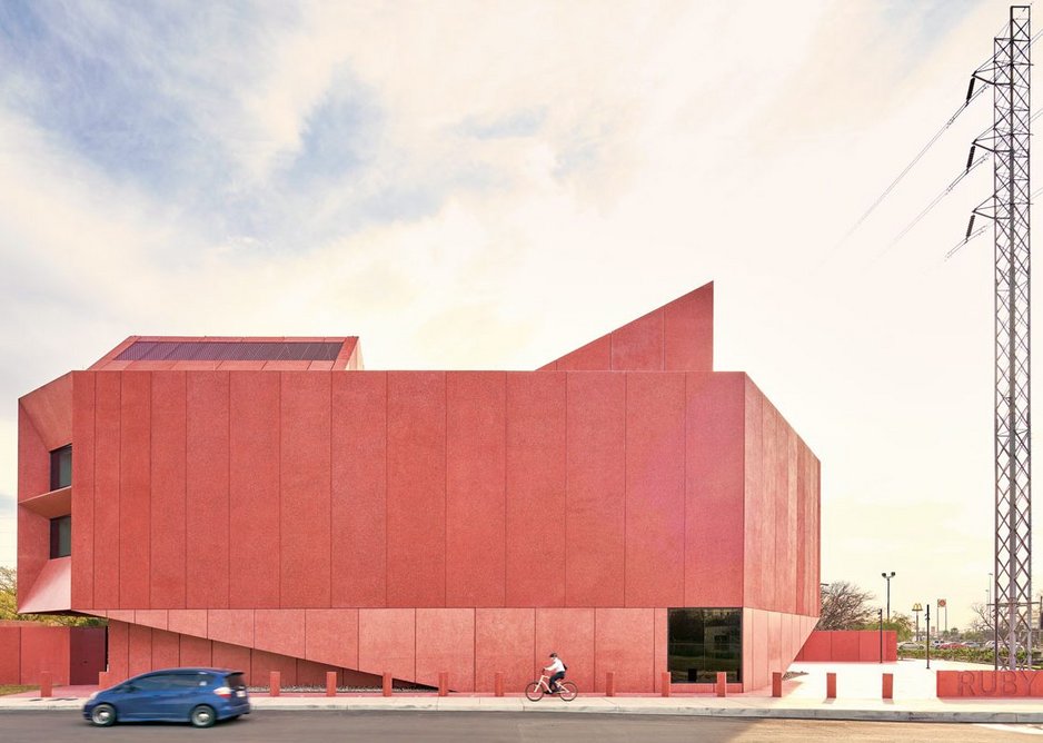 Red concrete panels that shimmer in the light clad this 1,300m2 gallery, Ruby City in San Antonio, Texas.