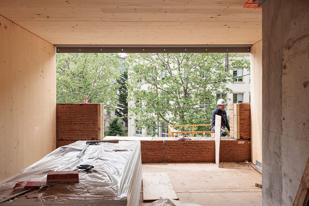 The principal materials of the building are rammed earth, cross-laminated timber, stone and concrete – used for a lift core and a floor slab.