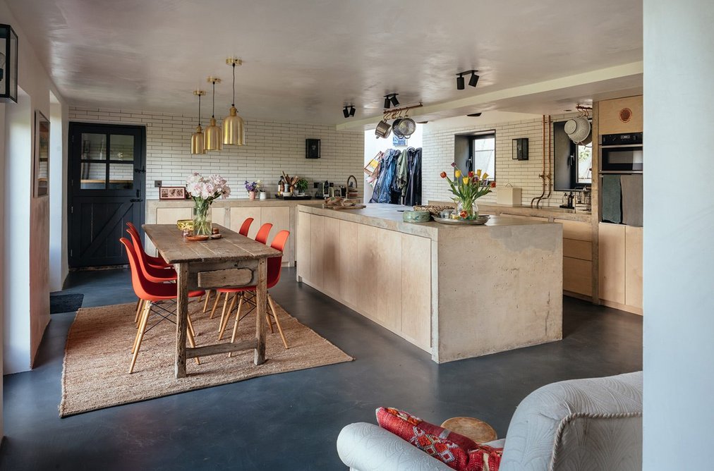 Concrete worktops and exposed copper pipes in the kitchen.