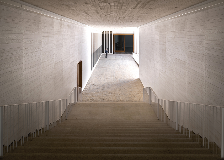 A dark but wide passageway leads down from the old town to the entrance bridge overlooking the courtyard.