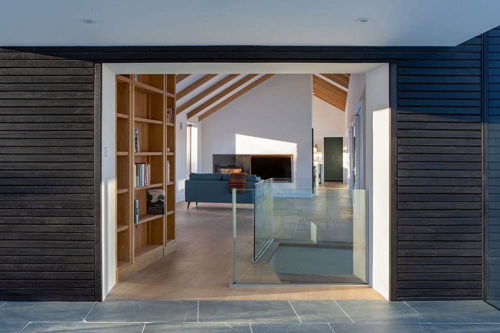 View through hallway, past stair leading to the ground floor, to the living room beyond.