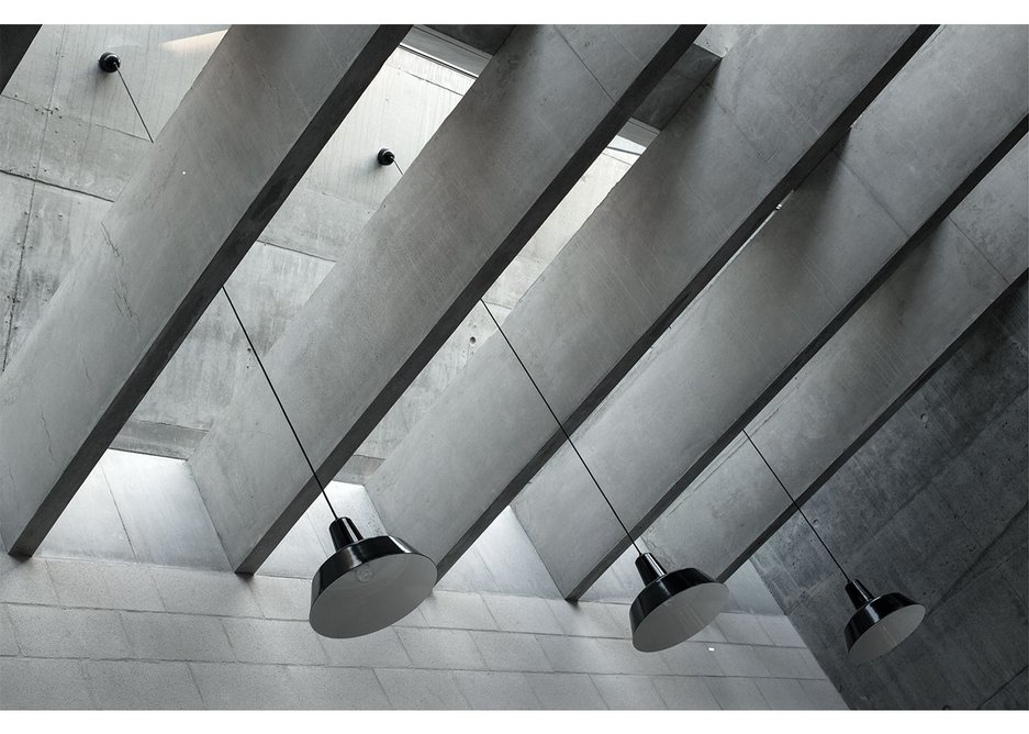 Concrete fin beams below the north facing rooflights of the studio space don’t only look impressive, they act as baffles to deal with potential solar gain from east or west.