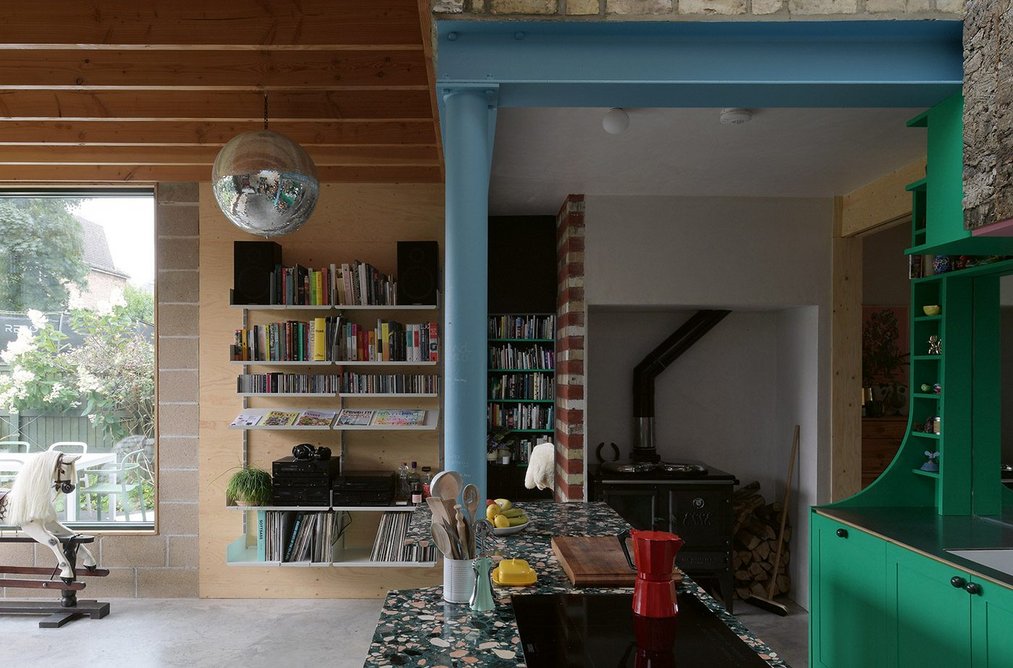 Blue painted steels combine with vivid green joinery and terrazzo counters. A mirrorball also joins in the fun.