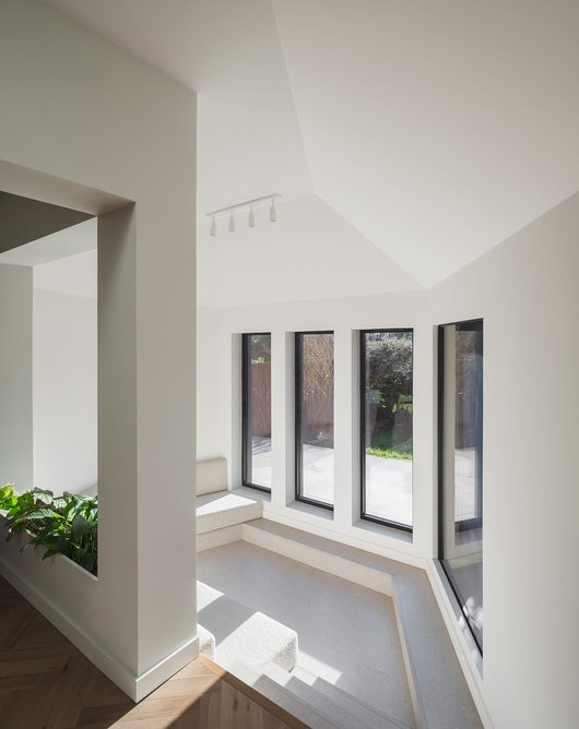 The sunken living space with its built-in seating in the extension.