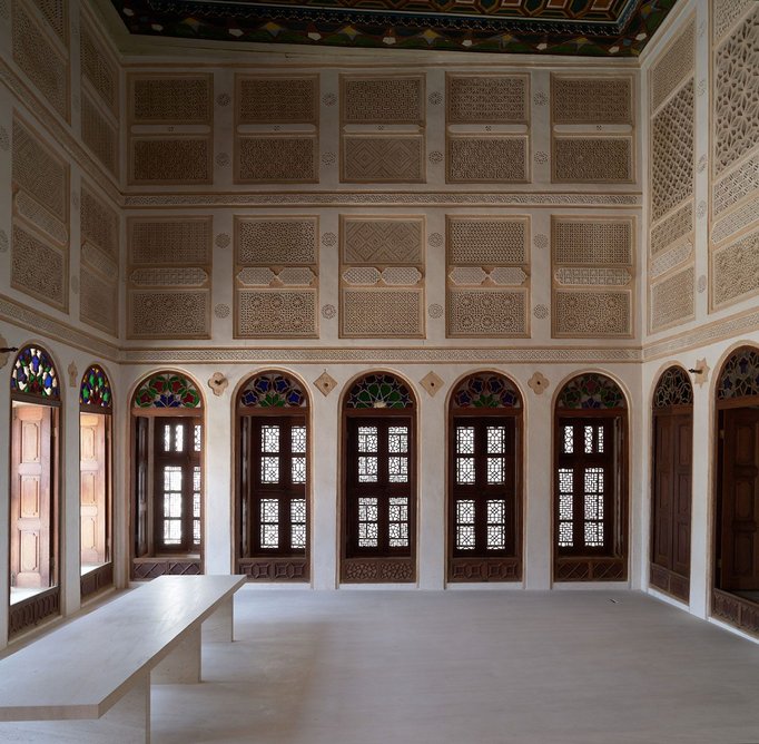 Intricate joinery and stained glass windows have been conserved in the majlis, built in 1921 above ground-floor apartments from the 1850s.