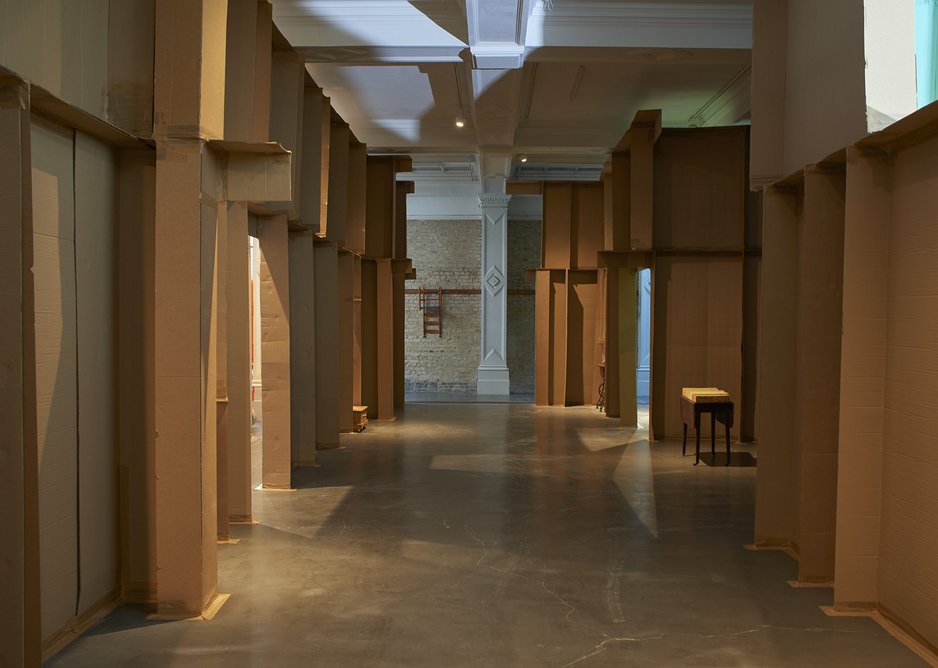 The two cardboard walls reference the changing area around the gallery.