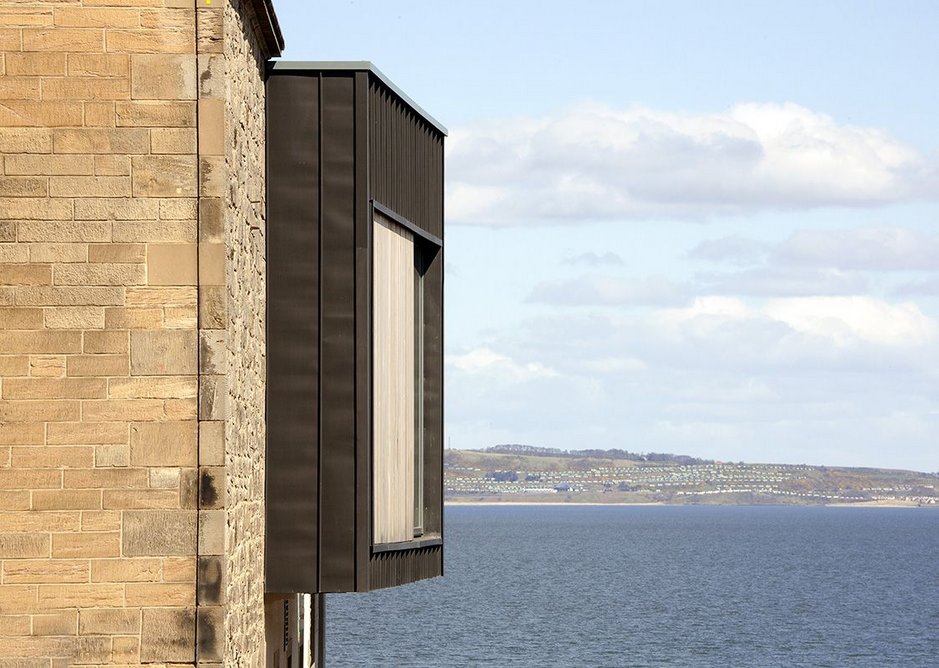 A zinc boxed bay window tops the corner of the daycare centre.