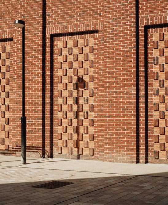 Undulating brick compositions animate facades at street level.