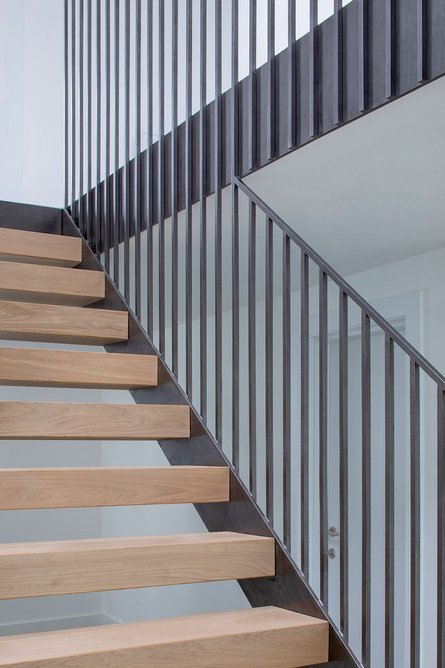 Steel and timber open tread stair down to the garage level.