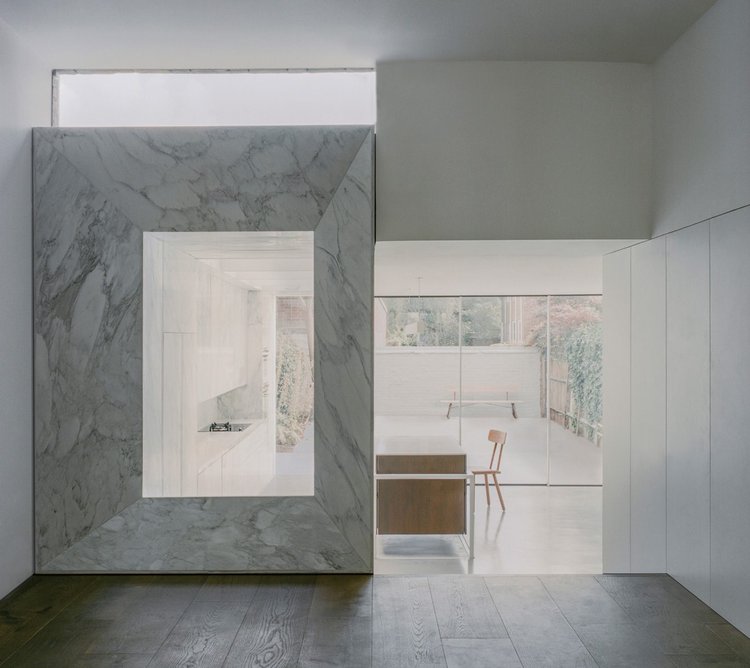 Marble-framed view into the extended kitchen from the lounge.