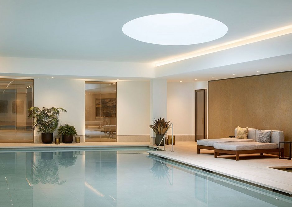 The swimming pool, one of many communal amenities in the basement. Porcelain floor and wall tiling by Domus supply the required durability with the appearance of limestone.