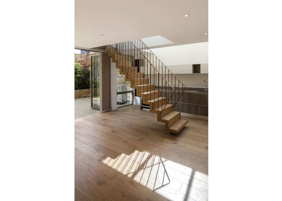 In the end house,  a bespoke steel and oak stair treads lightly.