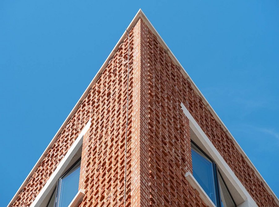 Snap header brickwork and sharp corners add dramatic interest to the streetscape.