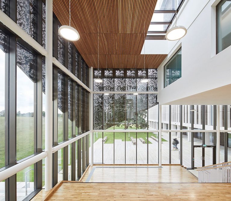 Filigree aluminium panelling drawn over the curtain-walled facade to the main reception area is intended to create a sense of ceremony on arrival.