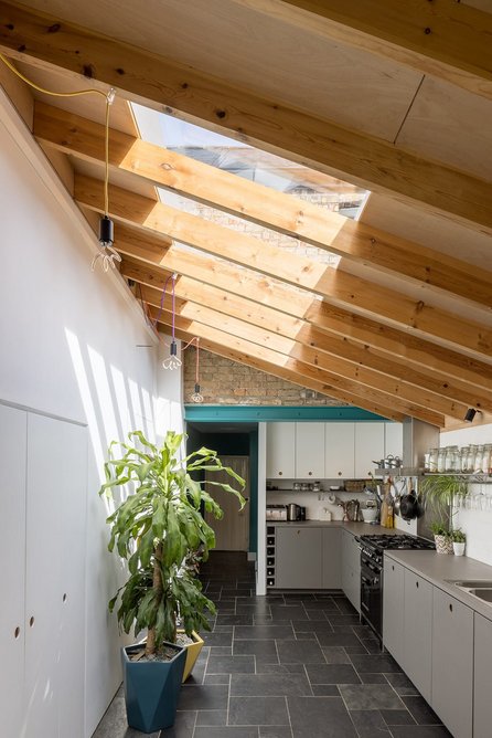 The master bedroom overlooks the mono pitched roof of the extension below.