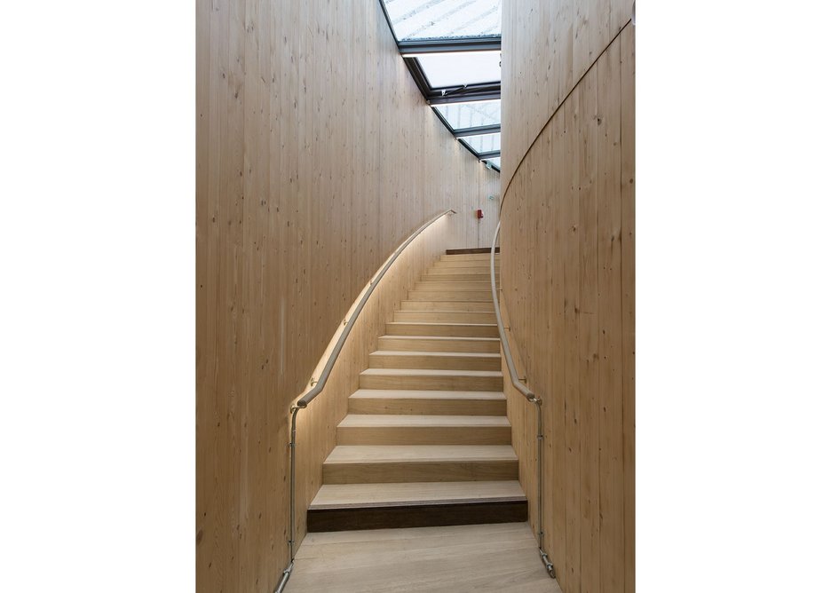 Glulam lined stairs take you up to the balconies.