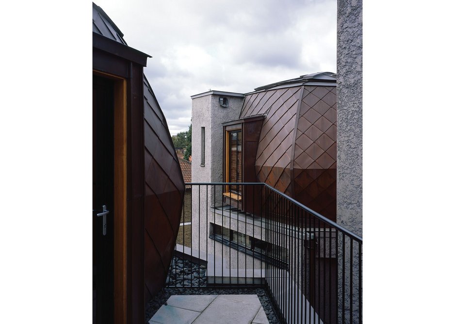 Houses A, B & C are crowned with copper-clad timber yurts, creating a strange bespoke roofscape.