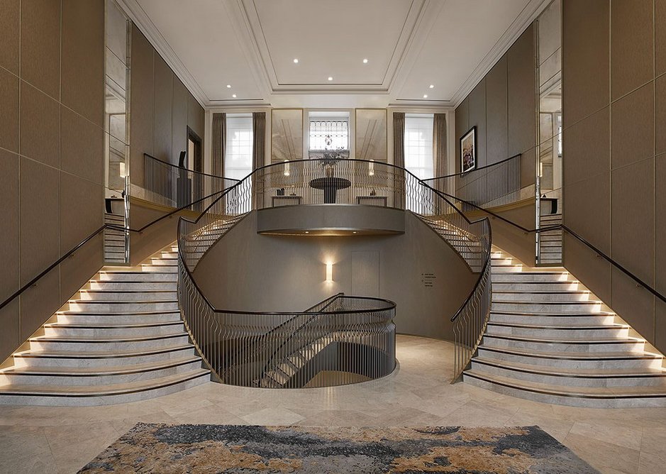 A double staircase sweeps down from the main entrance on the crescent to the reception. Interiors are by Millier London, which combined pale limestone flooring from Tasca Stones with contrasting dark metal detailing.