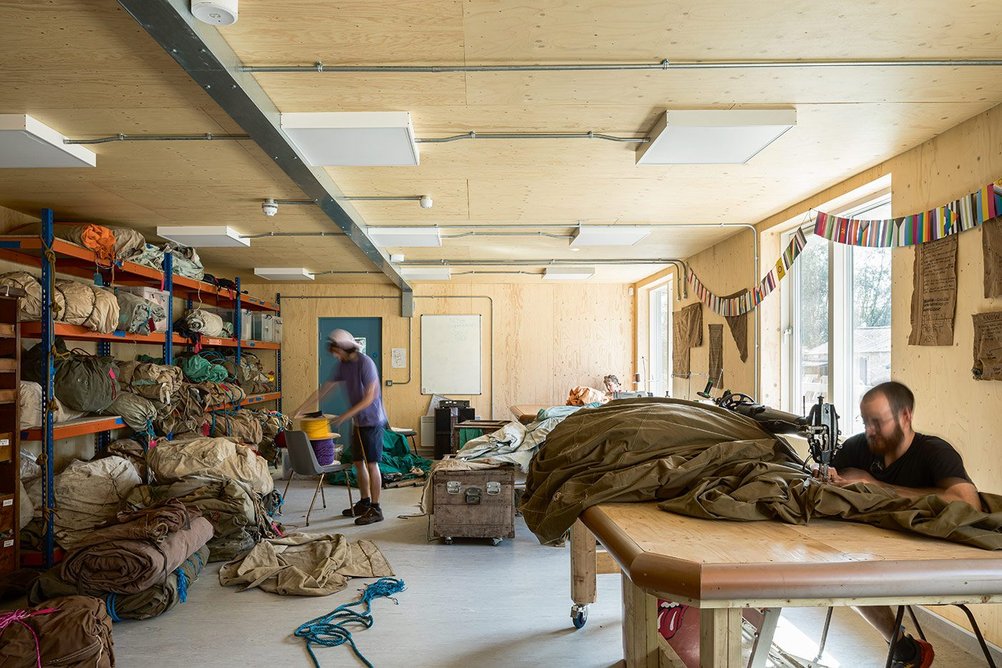 An old industrial-sized sewing machine makes tent repair a breeze.