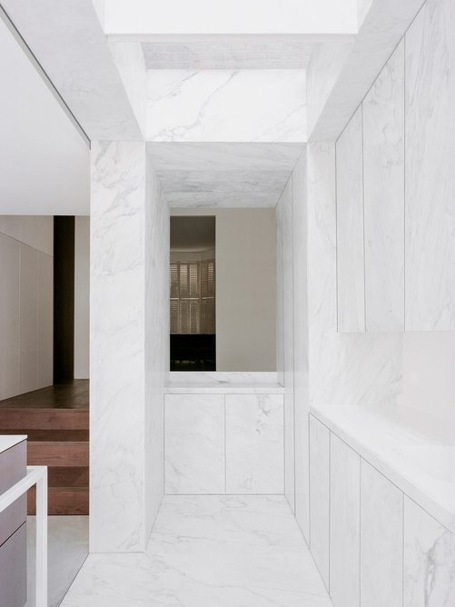 Corian countertops complement the Carrara marble.