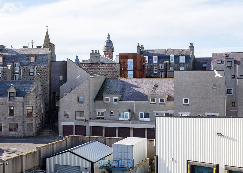 Viewed from the harbour side, the new extension slips into the existing roofscape.