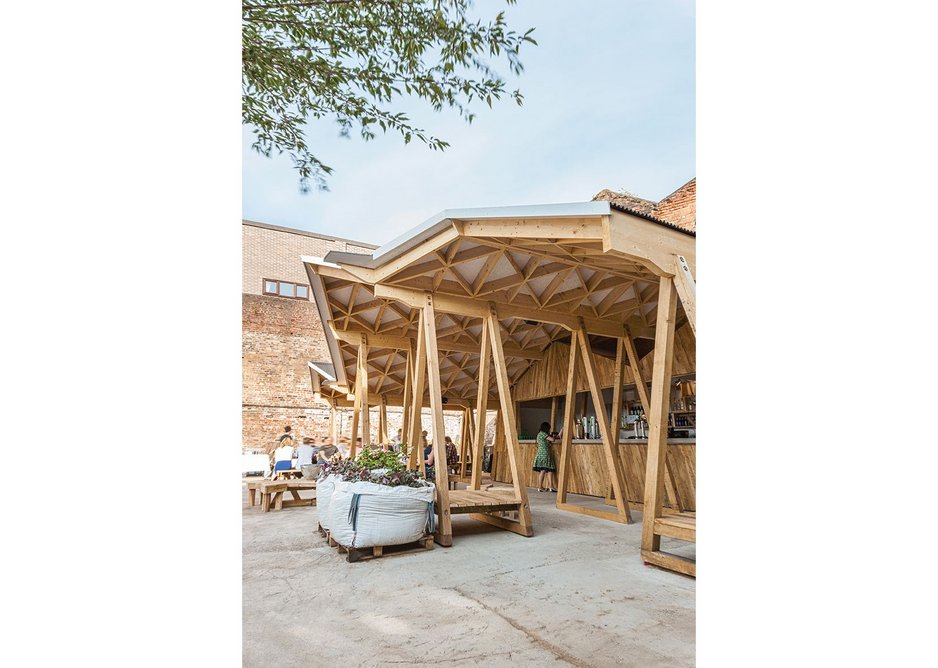 Trestles that support the roof double as seating.