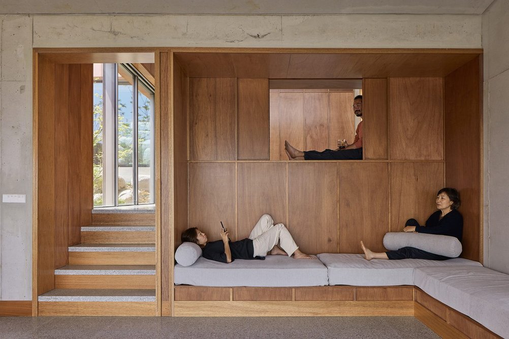 The Lauran timber plywood partition between the living space and main bedroom at Studio Weave's Seosaeng House. It doubles as extra sleeping area.