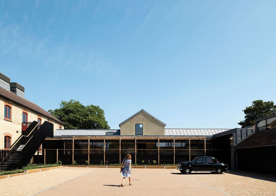 The glazed ‘long gallery’ across the length of the building ties the three parts together.