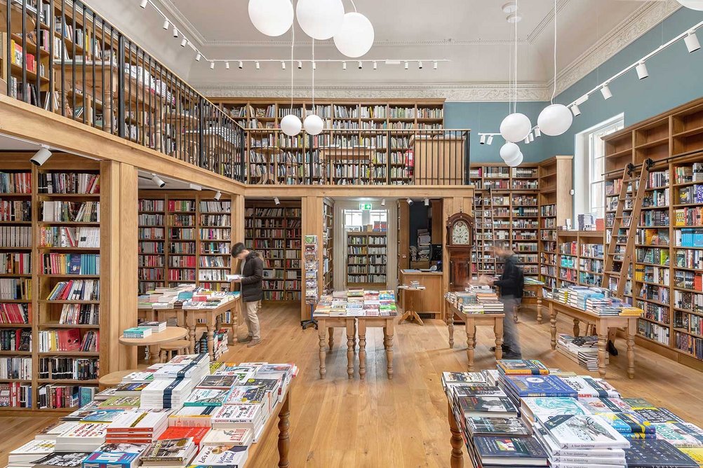 A book ladder gives the sense of a library, part conceit and part practical solution to tall shelves.