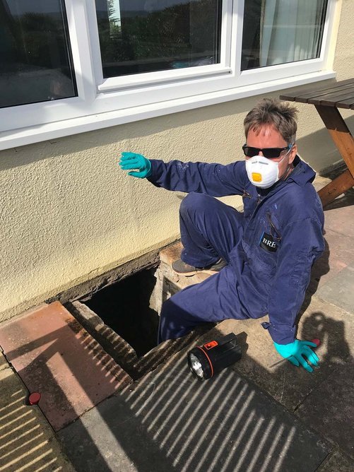 Dr Rob Verkerk heading into the underfloor void of one of the houses to inspect the monitoring stations.