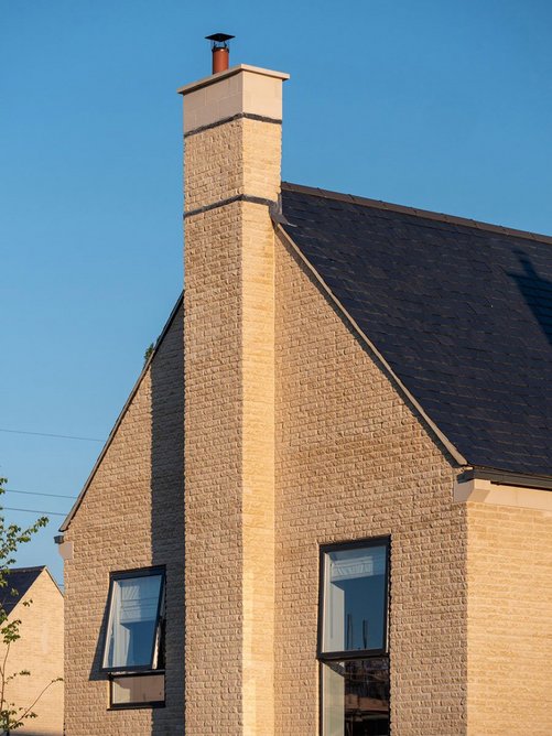 Crisp details: chimney on premium home with walling stone and semi-dry cast stone components.