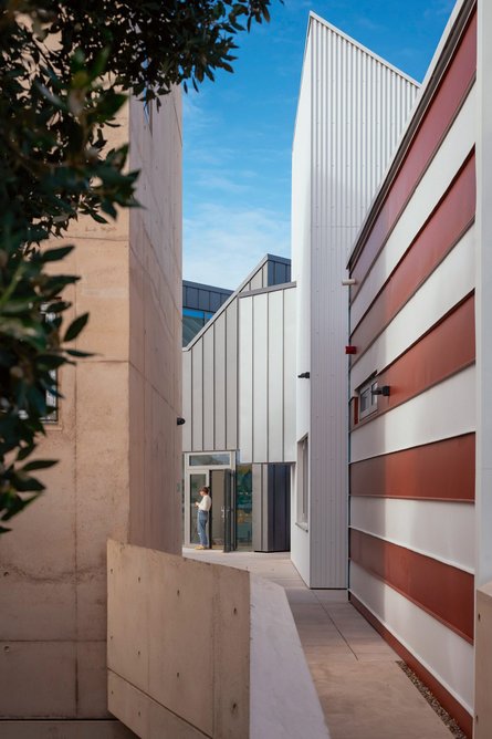 The first floor is open to walk through with this alley and decks accessing the makers’ studios while connecting them to the courtyard below.