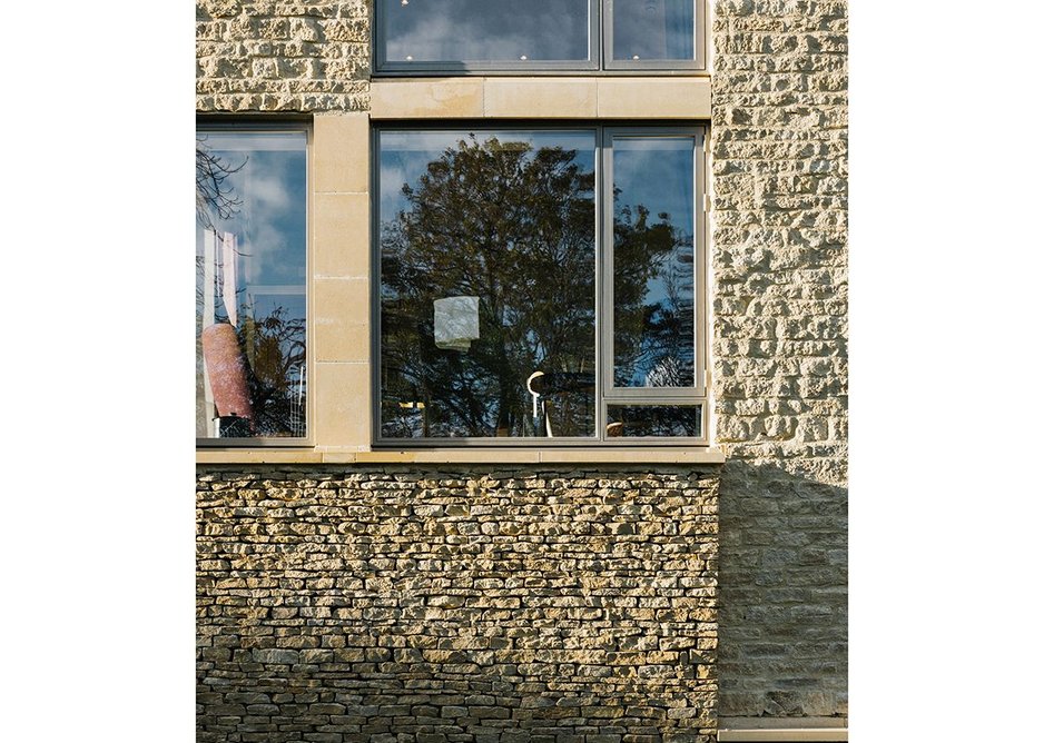 Limestone is laid like a boundary wall and then taken onto the front of the building with its more refined ashlar columns and oversized chimney to a shared residents snug.