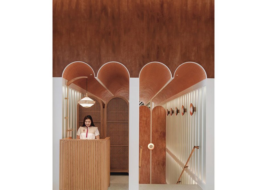Reception desk at John Anthony, a dim sum restaurant in Hong Kong fusing the architecture of East and West.
