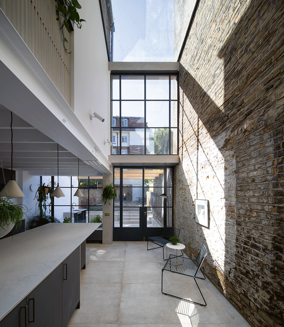 At Hannington Rd, the party wall becomes a feature wall, creating an imposing double height space in the process.