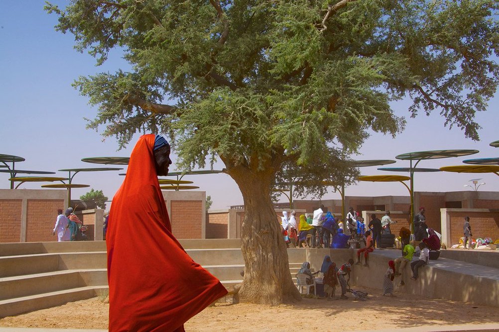 Mariam Issofou Kamara designed the market in the village of Dandaji, Niger, 2019. The Dandaji market provides 52 enclosed stalls and colourful round canopies that shade each individual slot.