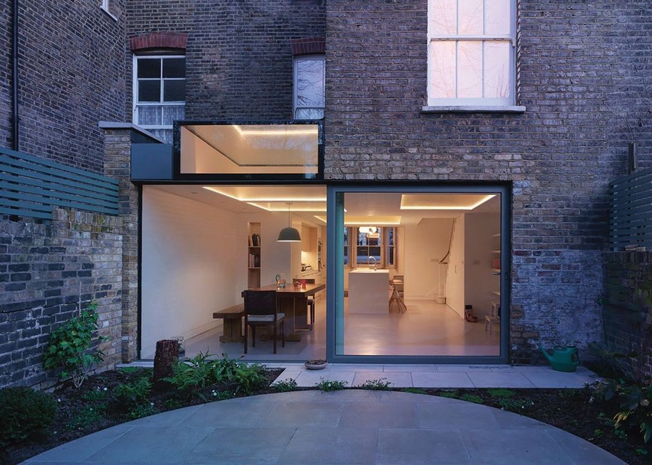 Plywood coffers push up into the ceiling for a roof lantern in this basement turned kitchen at Witherington Road, London.