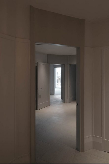 View from an entrance hall to the facade through the deep plan of a flat.