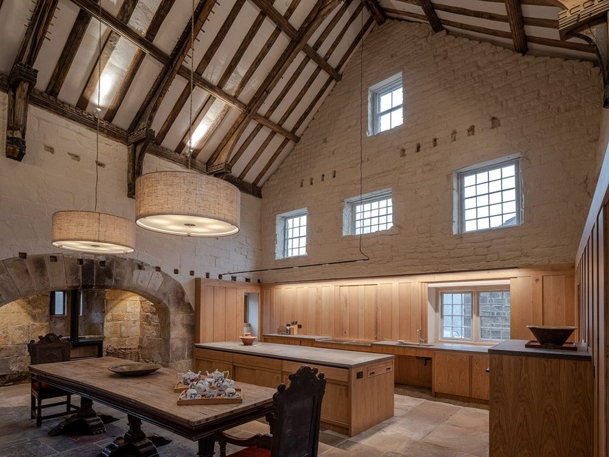 Bespoke wood panelling breaks up the lofty Great Hall.