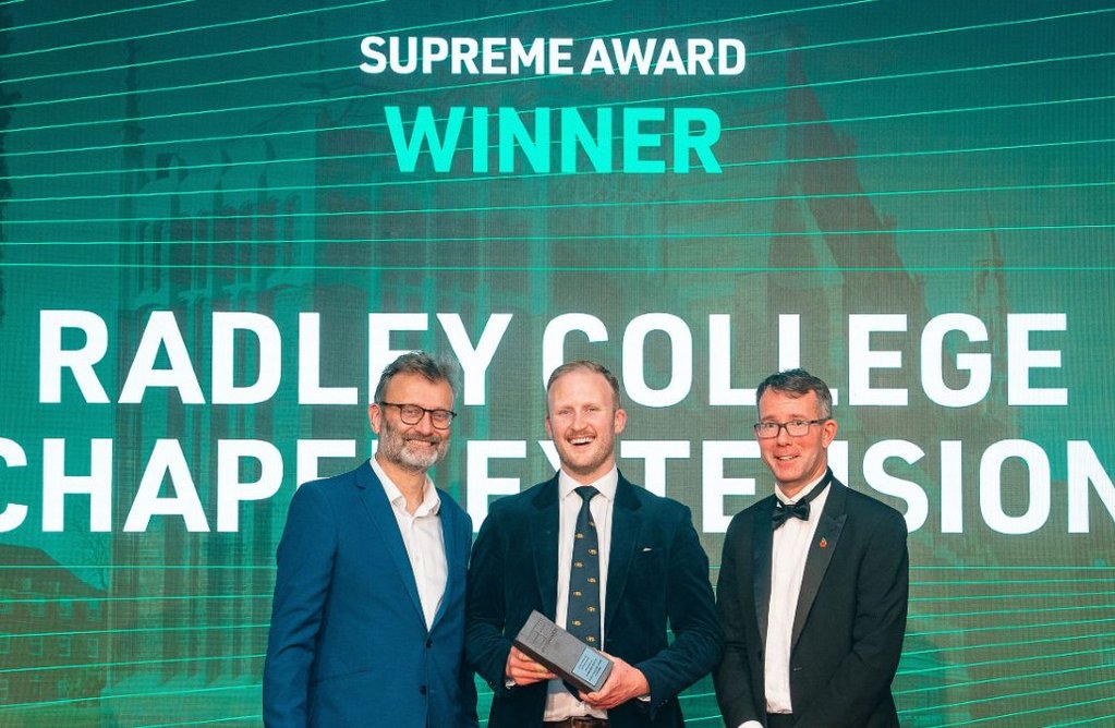 Supreme Award winner Radley College chapel extension: host and presenter Hugh Dennis with Josh Greig from Purcell Architecture and Scot Denham from awards sponsor IG Masonry Support.