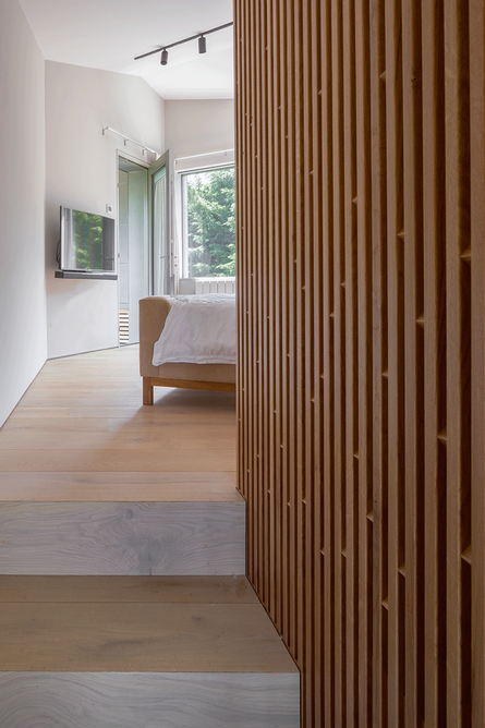 Sneaking past the bespoke oak wardrobe joinery up another level in the master bedroom.