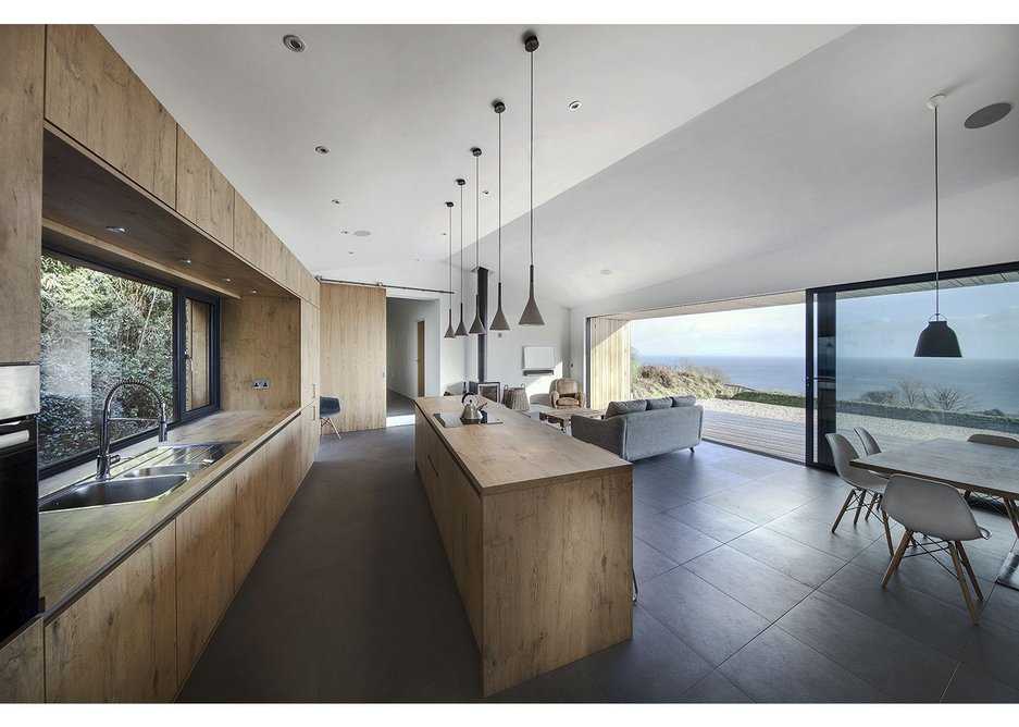 Central living area looks out to sea while firmly resisting sliding into it.