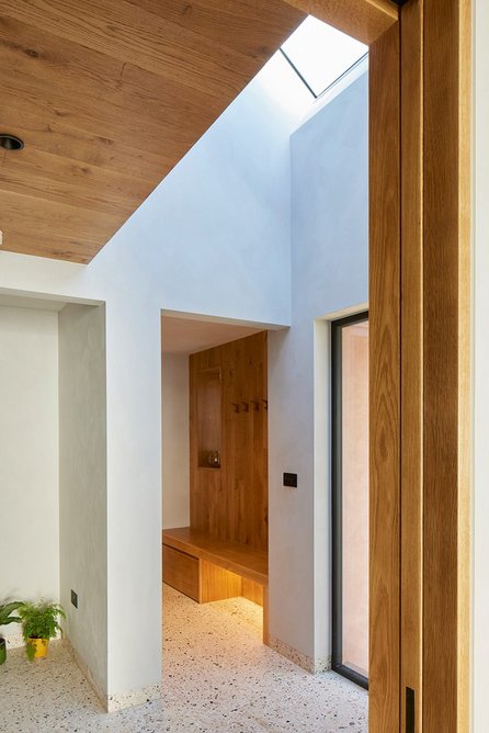 View through the hall to boot room, the void connecting the galleried landing above.