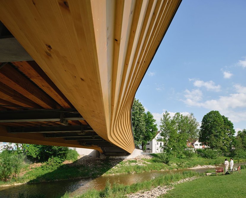 The timber bridge was conceived as a sympathetic response to the natural river setting.